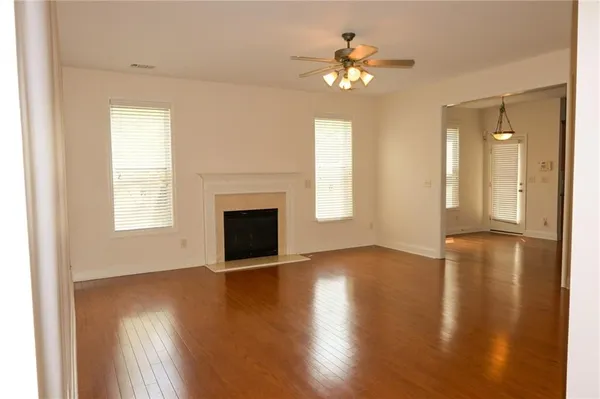 a living room with couches and painted walls next to a window