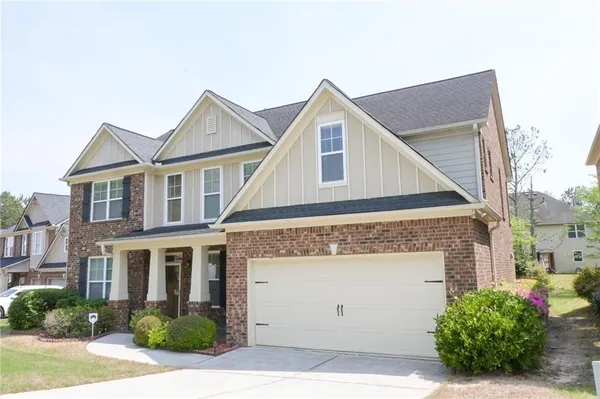 a kitchen with stainless steel appliances granite countertop a refrigerator a stove a sink and a microwave
