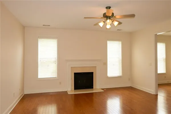 a kitchen with stainless steel appliances granite countertop a refrigerator a stove and a wooden floors