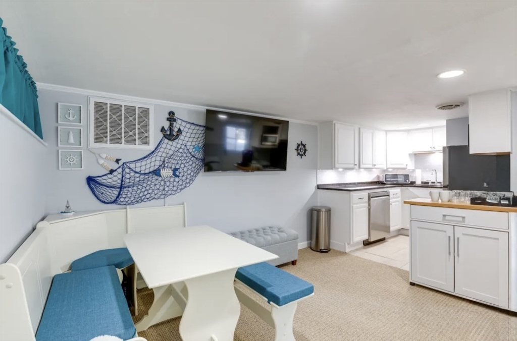 a kitchen with cabinets and chairs