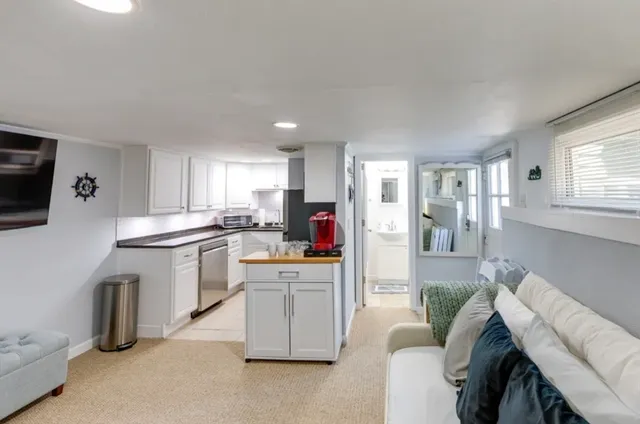 a kitchen with white cabinets and stainless steel appliances