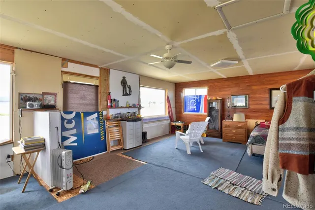 a living room with furniture and a kitchen