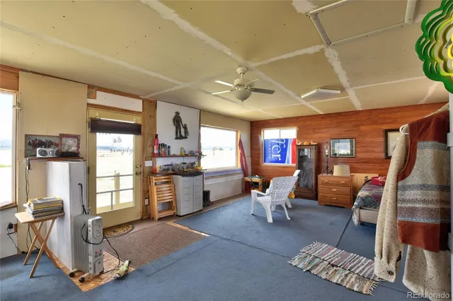a living room with furniture and a kitchen area