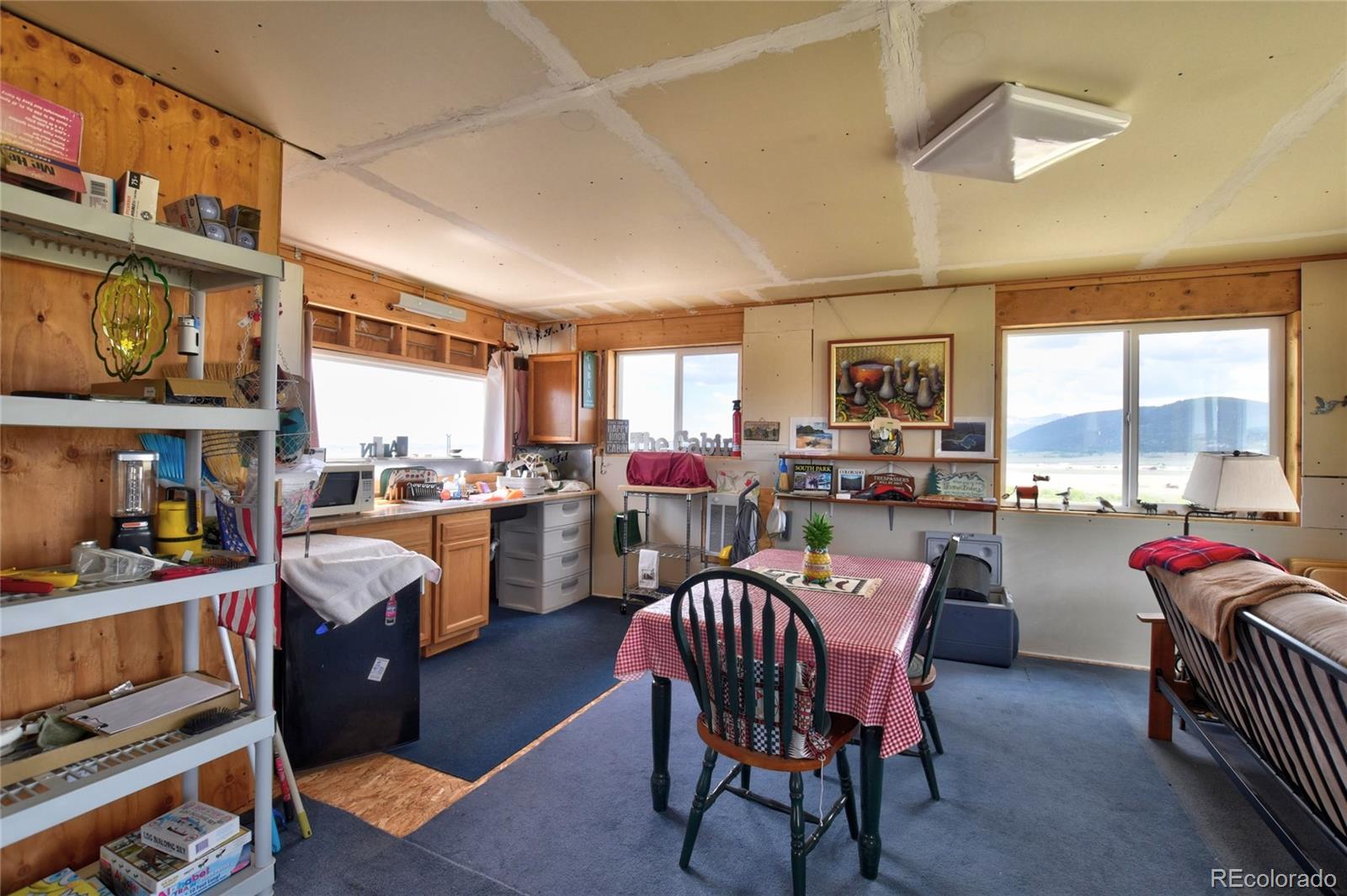 1091 Kokanee Road Fairplay, CO 80440 - Photo 16 of 34 a dining room with stainless steel appliances a dining table and chairs with wooden floor