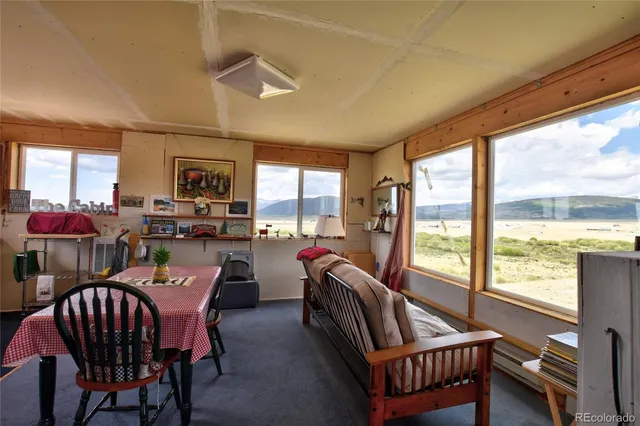 a view of a livingroom with furniture and a window