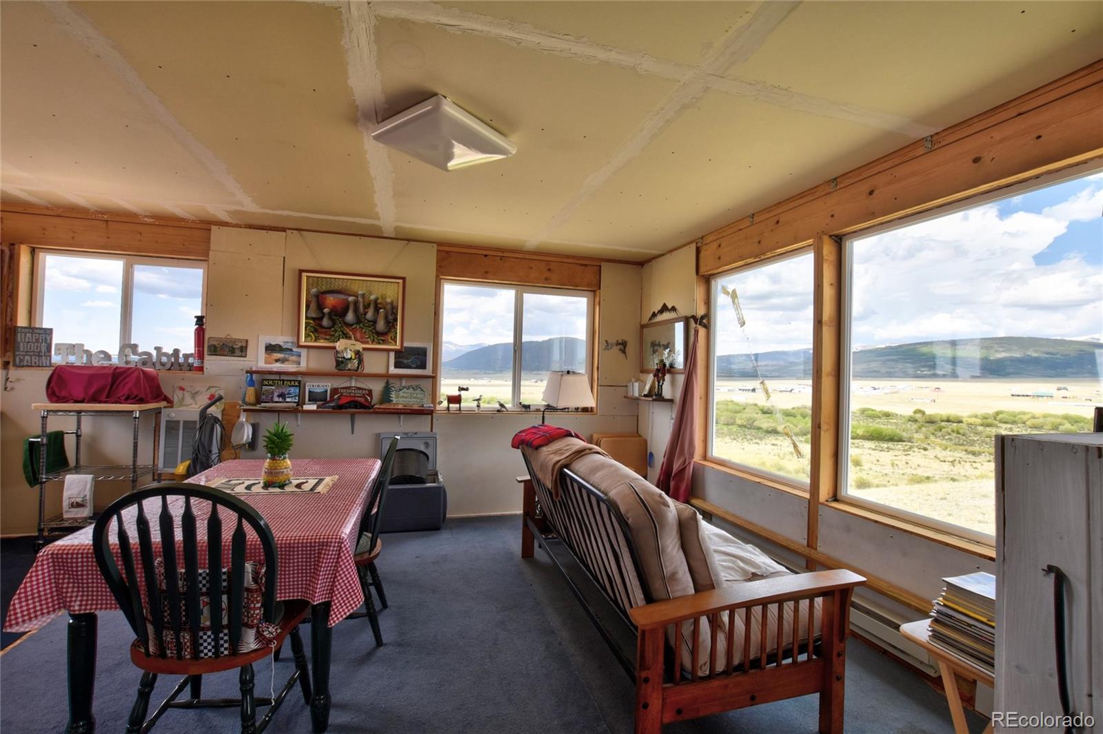 1091 Kokanee Road Fairplay, CO 80440 - Photo 18 of 34 a dining room with furniture water view and a floor to ceiling window