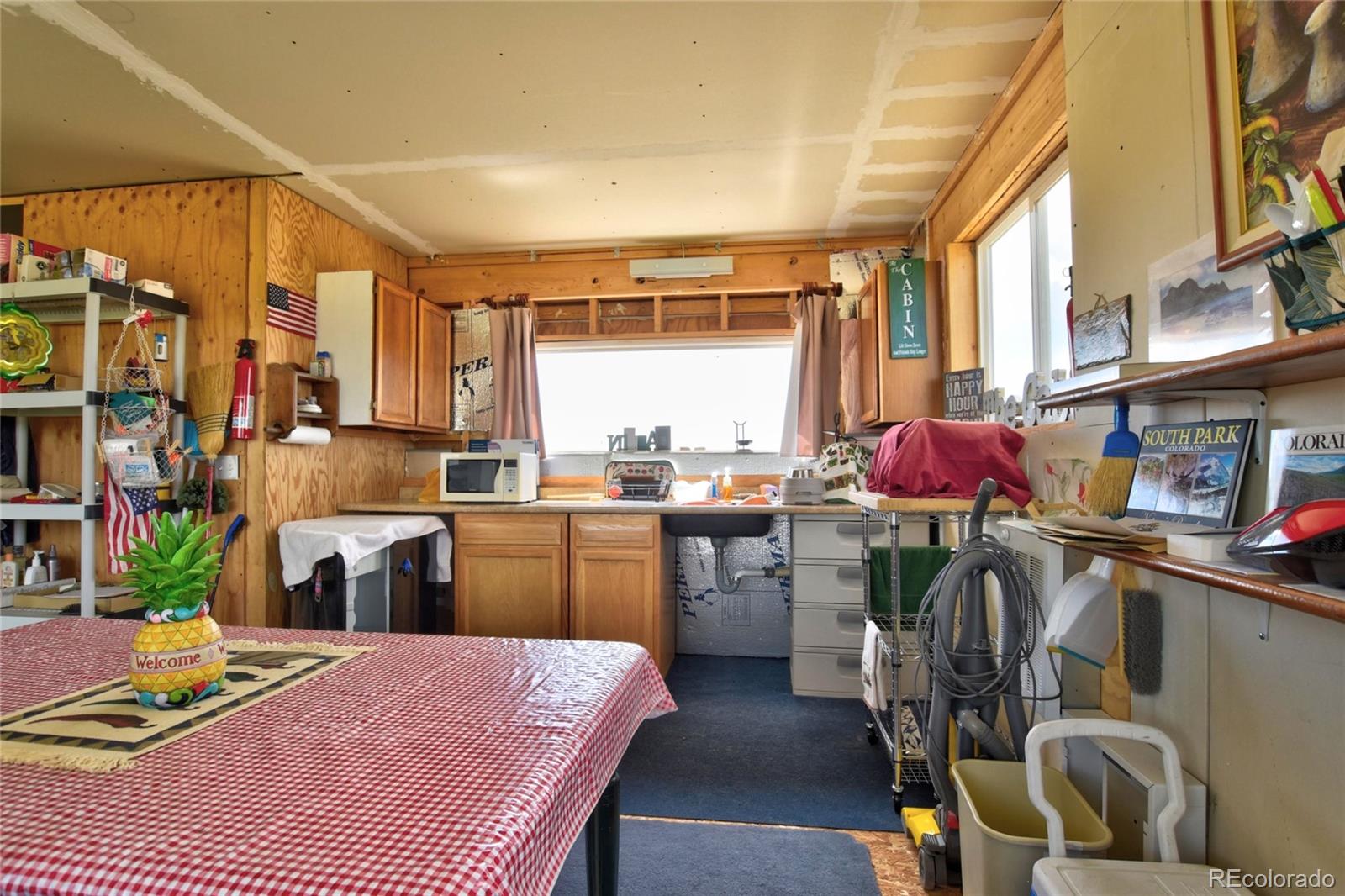 1091 Kokanee Road Fairplay, CO 80440 - Photo 4 of 34 a kitchen that has a lot of cabinets a sink and a stove in it