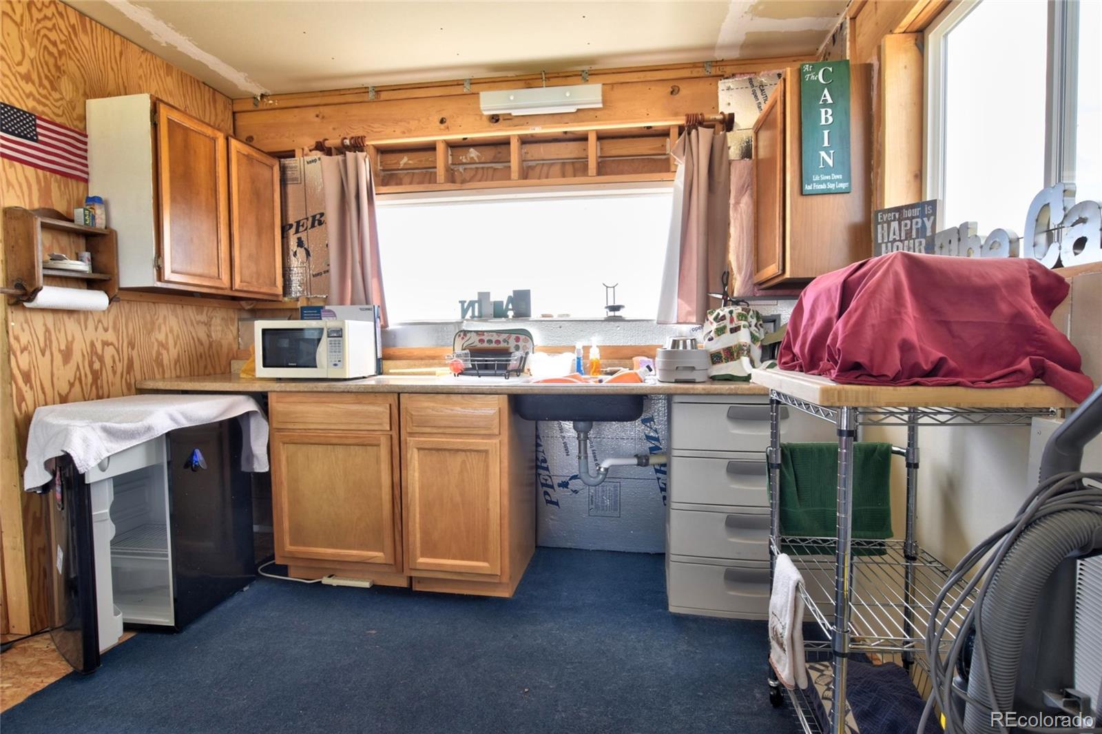 1091 Kokanee Road Fairplay, CO 80440 - Photo 7 of 34 a kitchen with a sink stove and cabinets