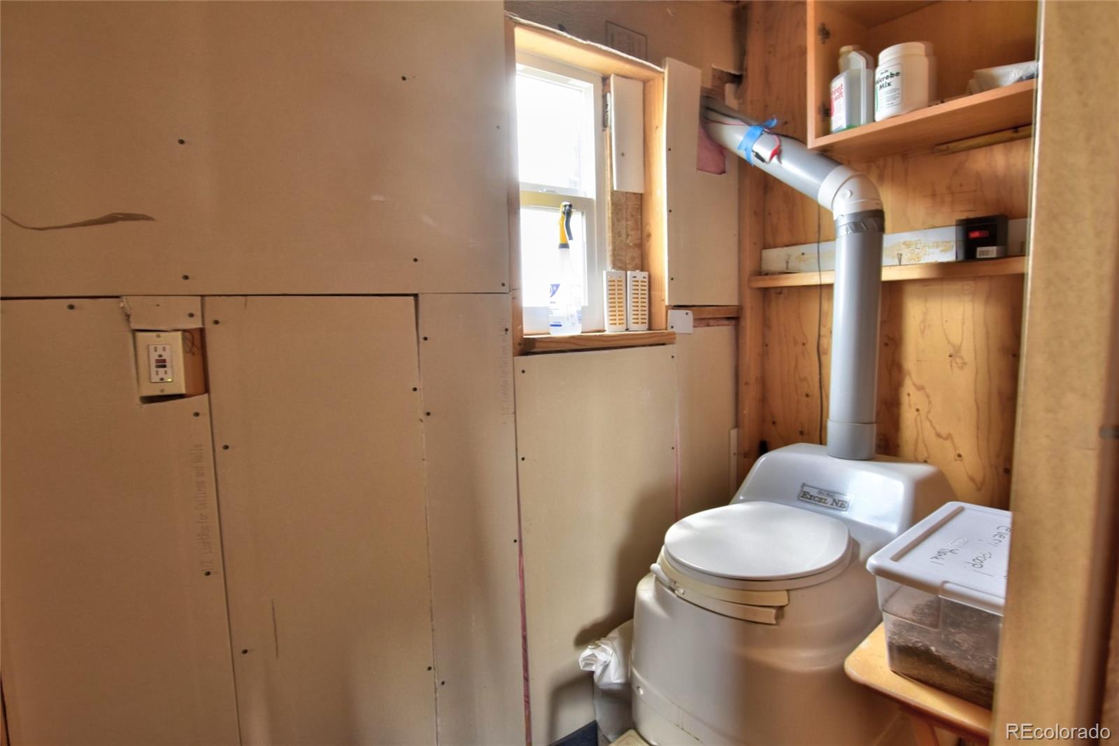 1091 Kokanee Road Fairplay, CO 80440 - Photo 10 of 34 a white toilet sitting next to a bathroom sink and a mirror