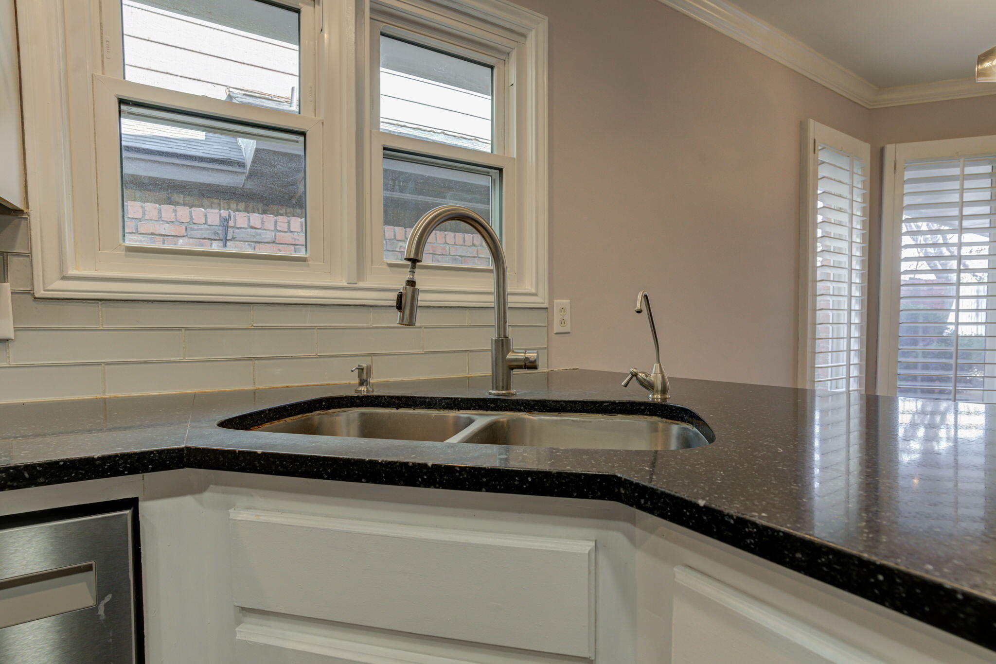 5107 1st Place Lubbock, TX 79416 - Photo 11 of 67 a close view of a sink and dishwasher with wooden floor