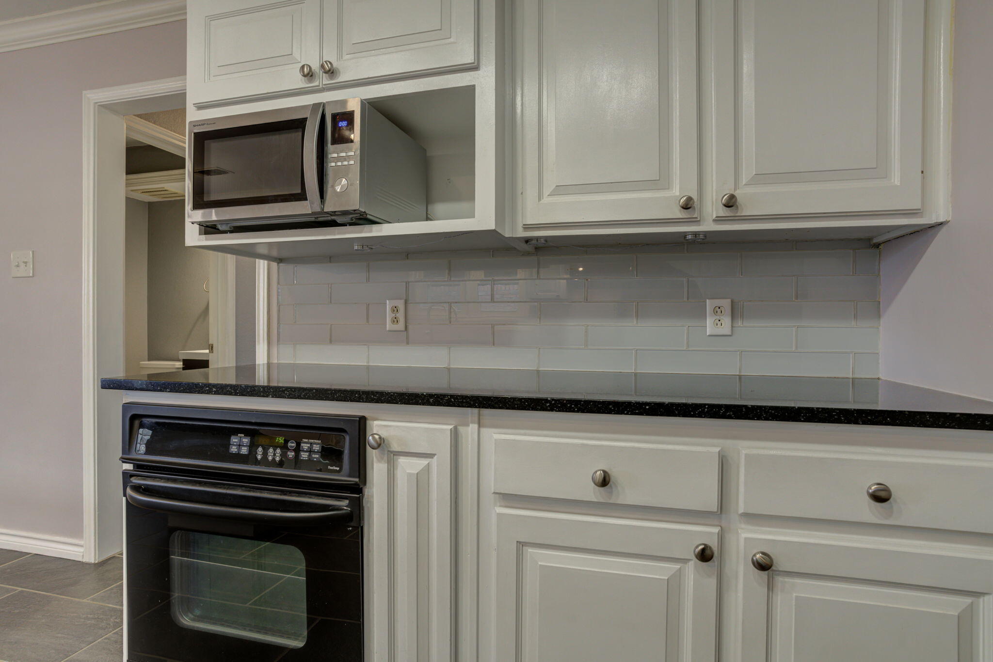 5107 1st Place Lubbock, TX 79416 - Photo 12 of 67 a stove top oven sitting inside of a kitchen