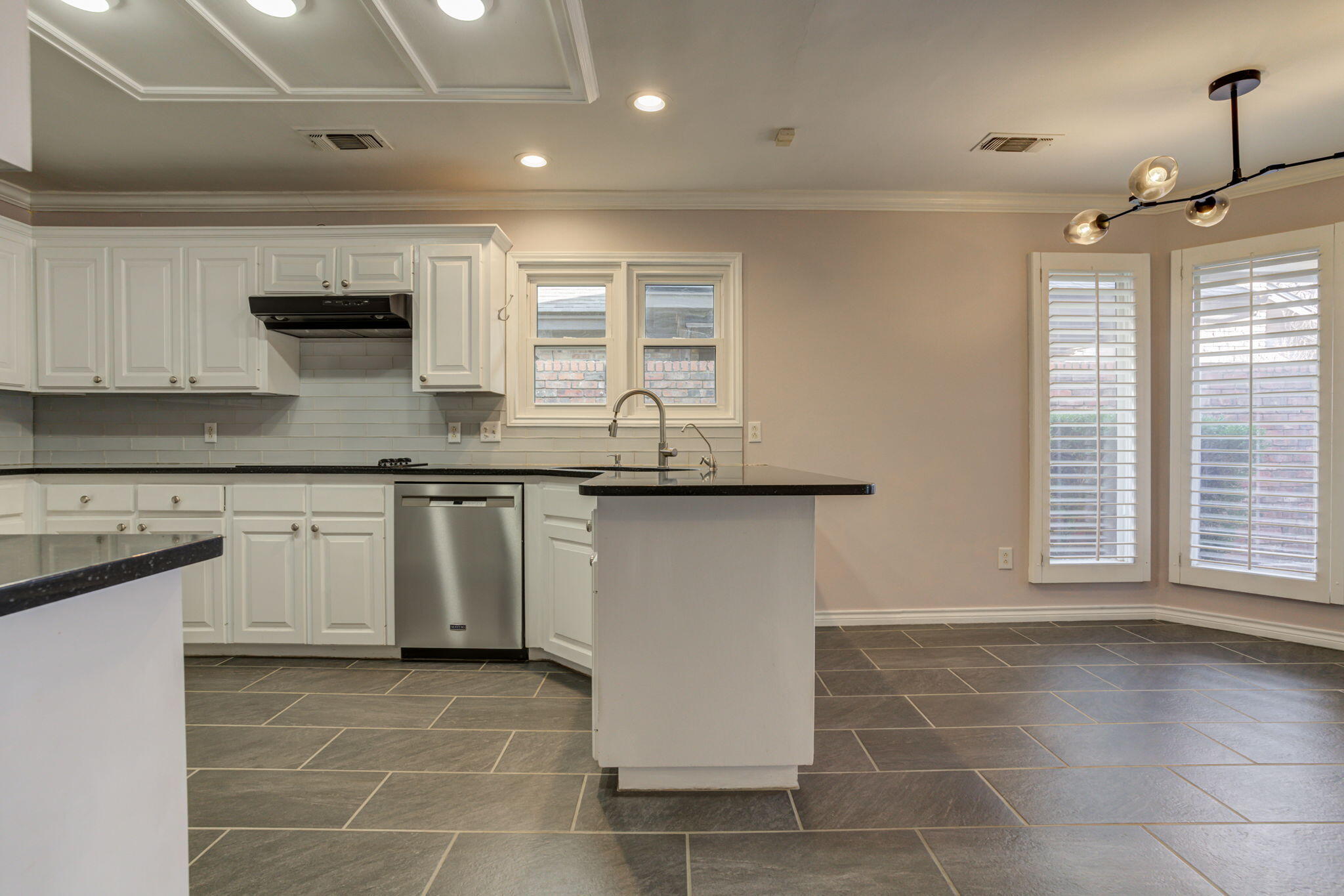 5107 1st Place Lubbock, TX 79416 - Photo 13 of 67 a kitchen with stainless steel appliances granite countertop a stove a sink and a microwave
