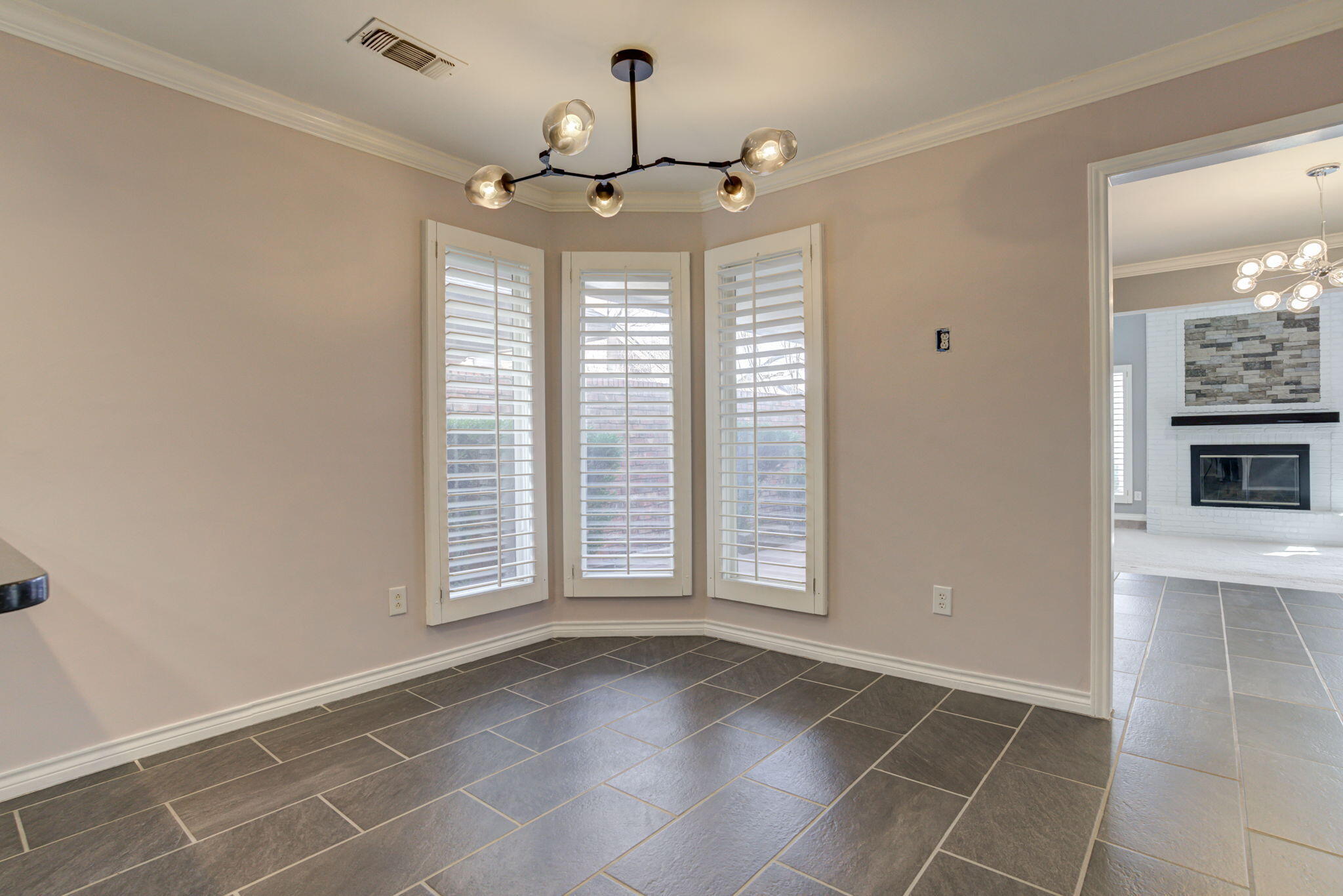 5107 1st Place Lubbock, TX 79416 - Photo 16 of 67 an empty room with windows and ceiling fan