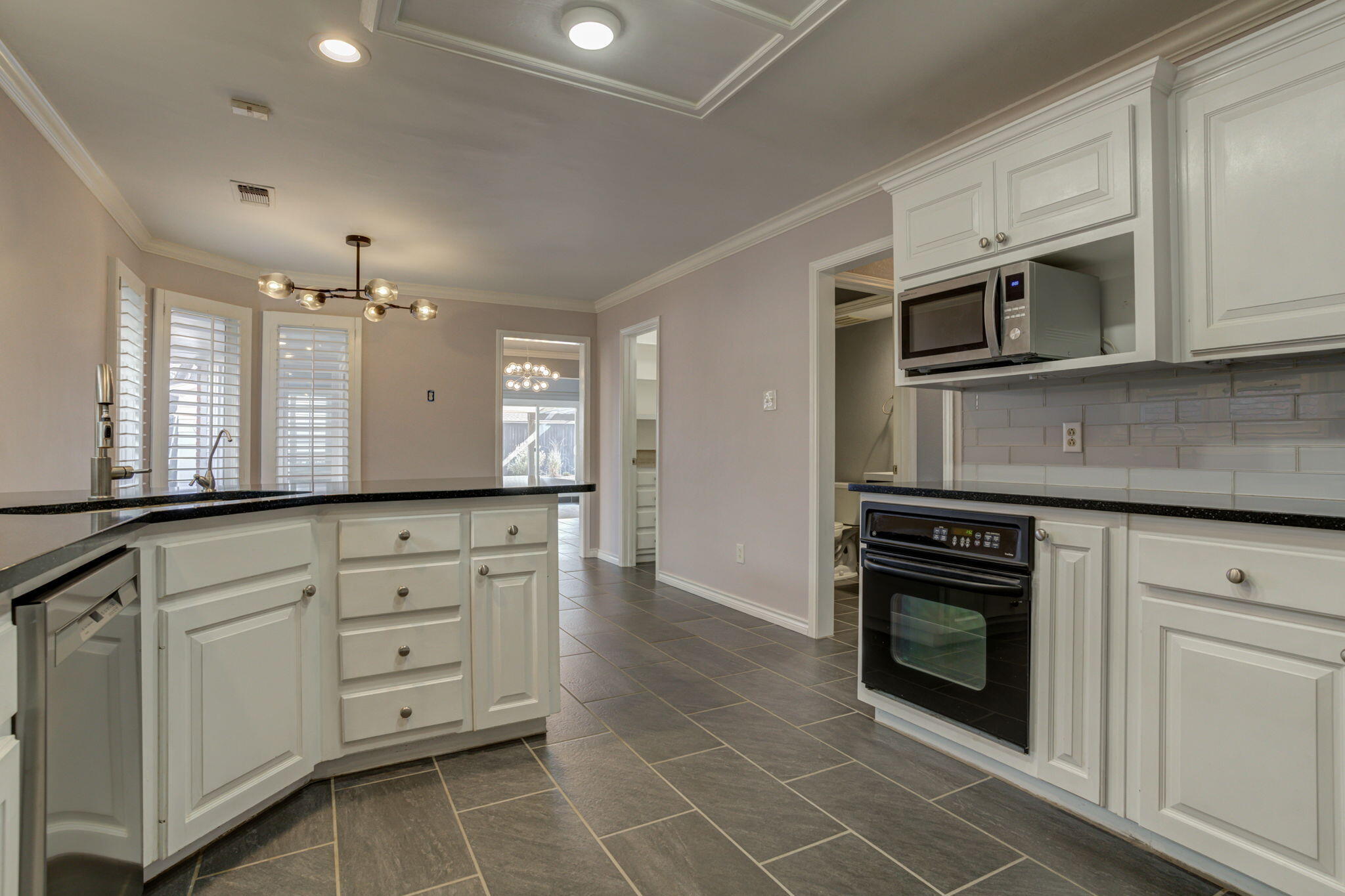 5107 1st Place Lubbock, TX 79416 - Photo 17 of 67 a kitchen with stainless steel appliances granite countertop a stove a sink and a microwave