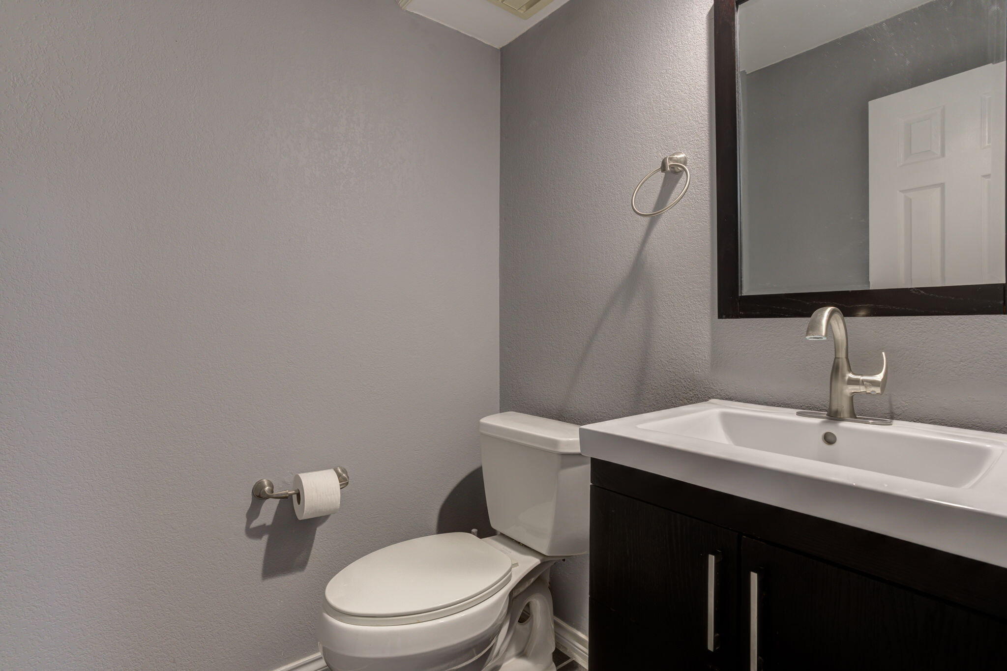 5107 1st Place Lubbock, TX 79416 - Photo 19 of 67 a bathroom with a sink a toilet and mirror