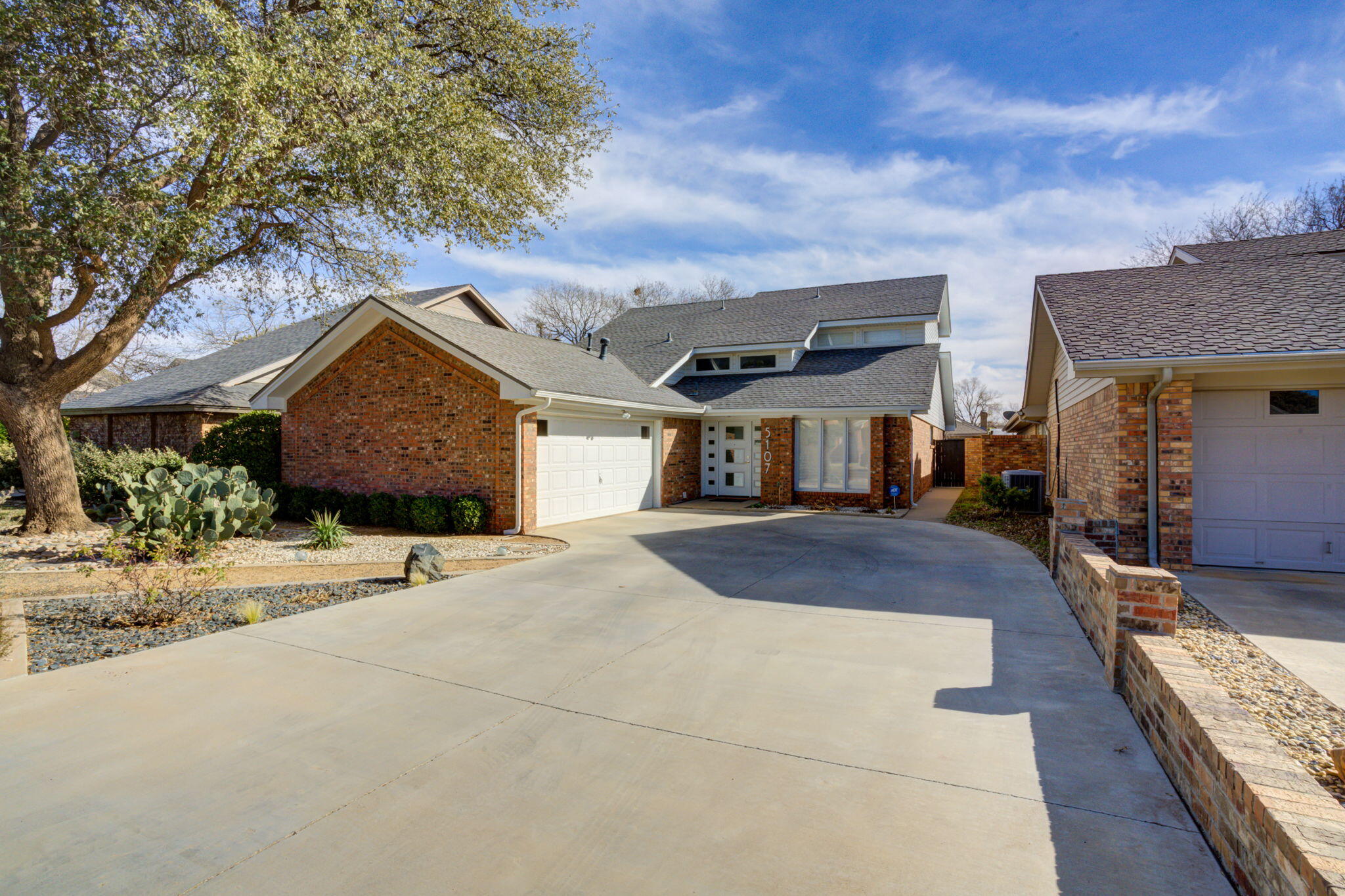 5107 1st Place Lubbock, TX 79416 - Photo 2 of 67 a front view of house with yard outdoor seating and barbeque oven