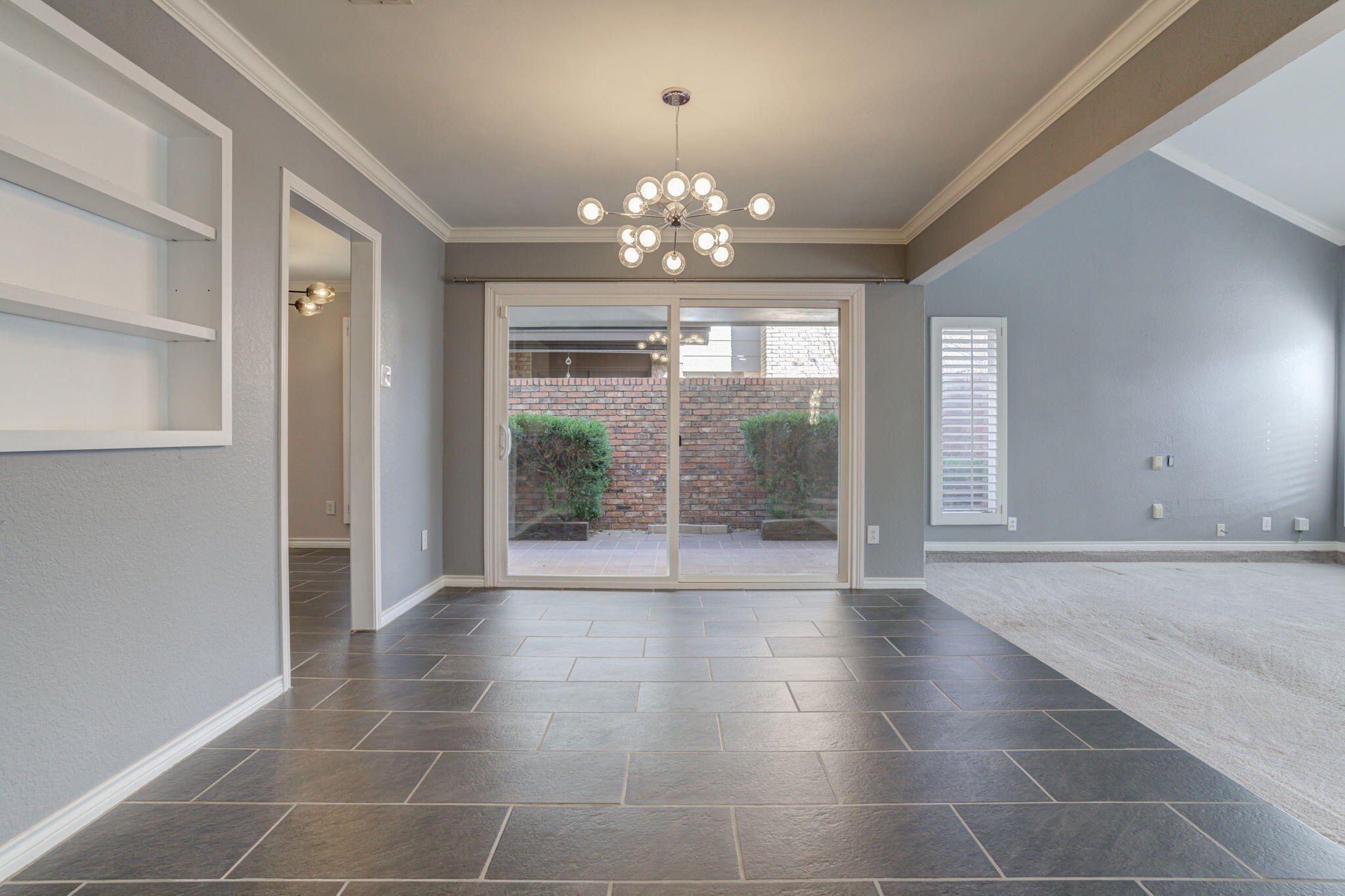 5107 1st Place Lubbock, TX 79416 - Photo 22 of 67 a view of an empty room with a window and chandelier
