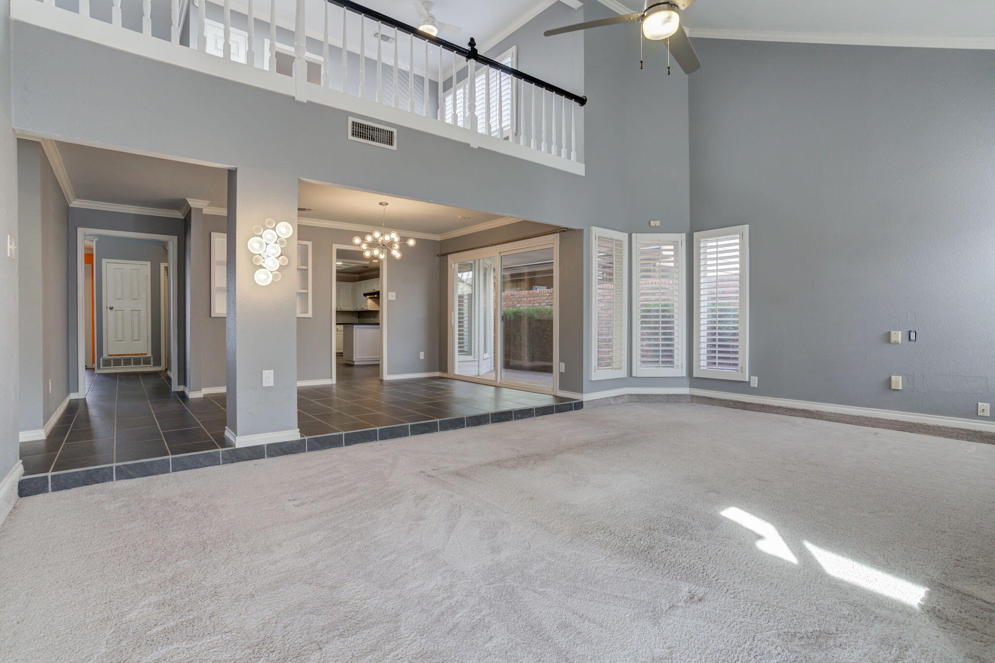 5107 1st Place Lubbock, TX 79416 - Photo 27 of 67 wooden floor in a hall with a large window and chandelier