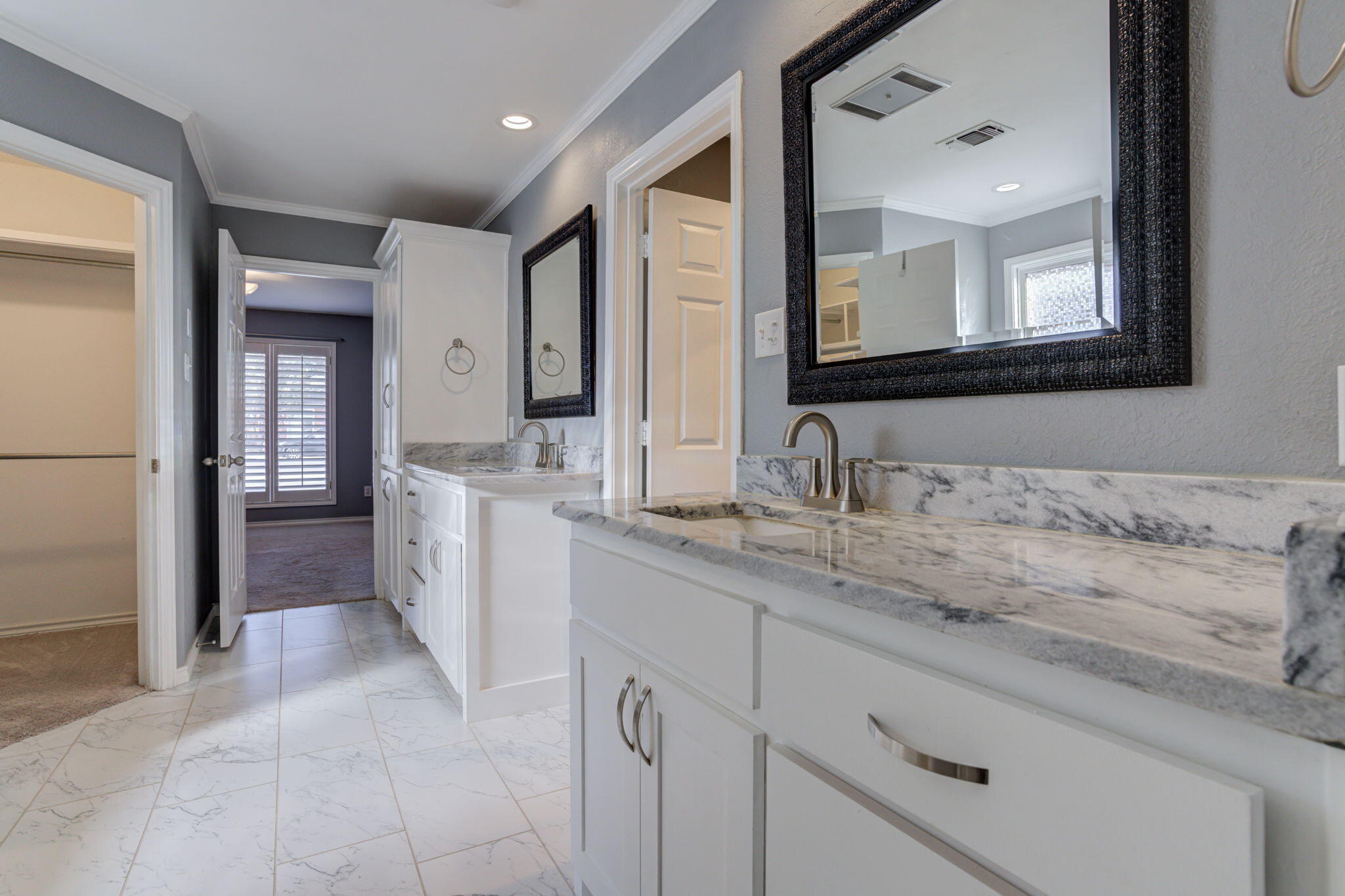 5107 1st Place Lubbock, TX 79416 - Photo 35 of 67 a en suite bathroom with a granite countertop sink and mirror