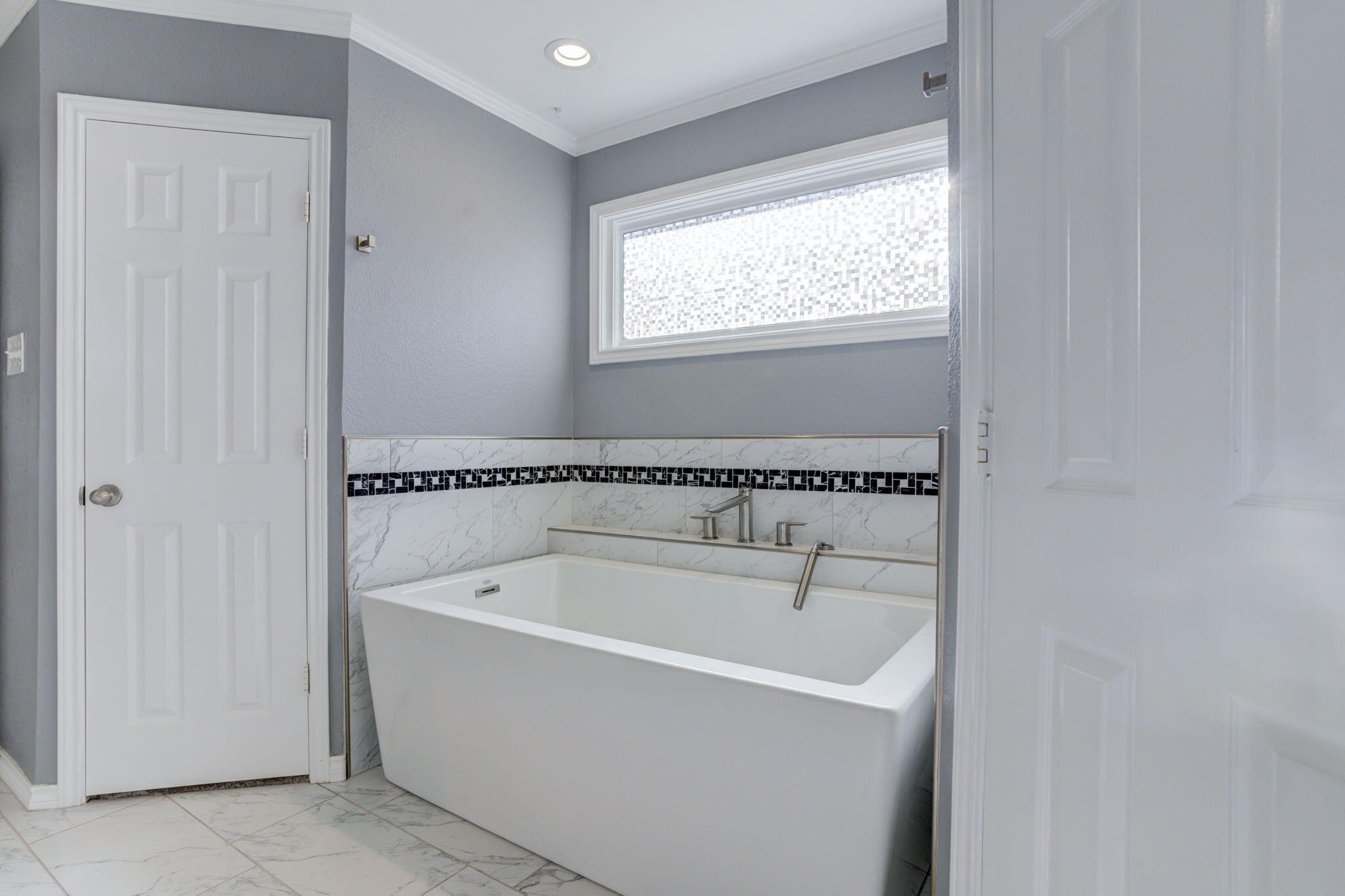 5107 1st Place Lubbock, TX 79416 - Photo 36 of 67 a white bath tub sitting next to a window