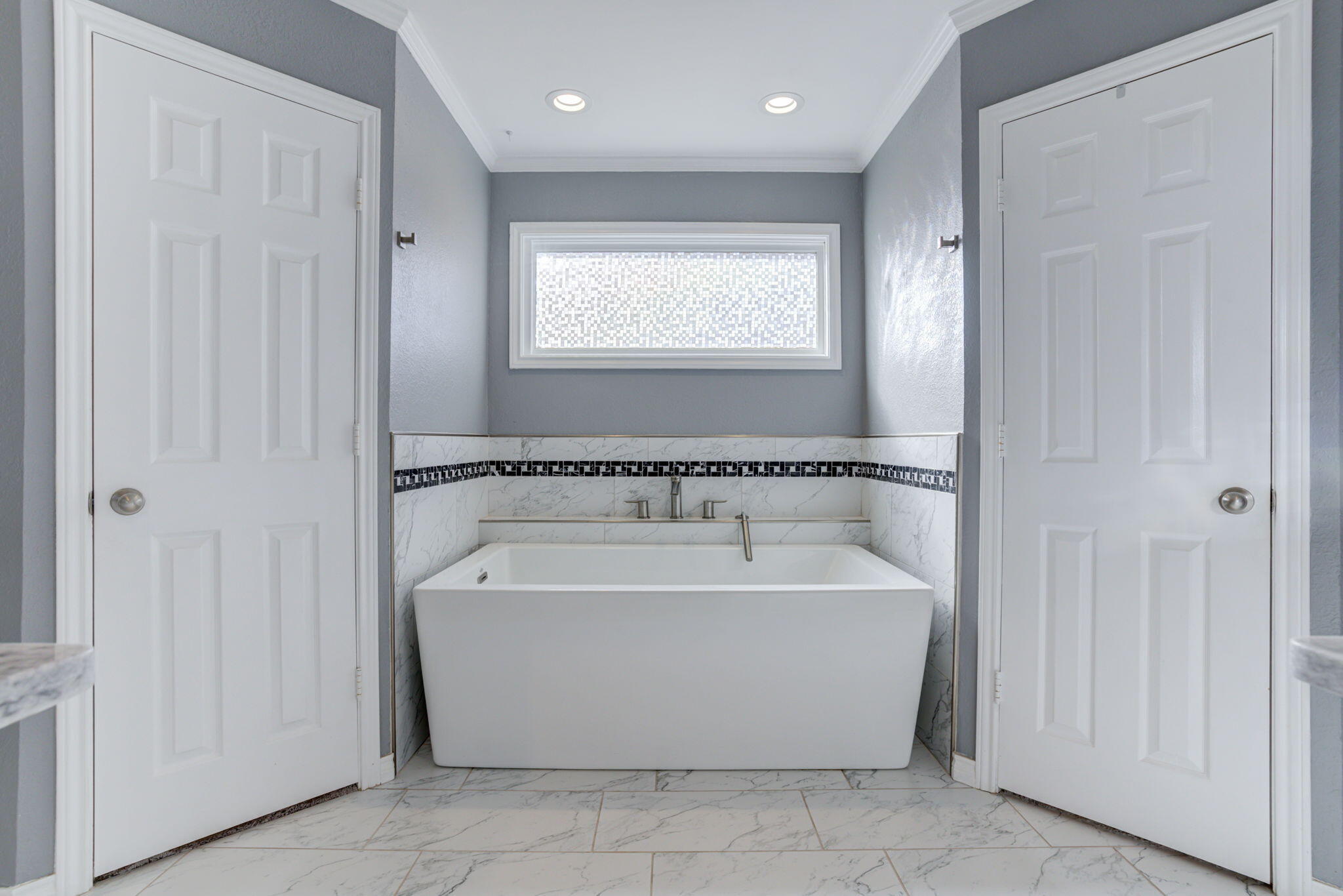 5107 1st Place Lubbock, TX 79416 - Photo 38 of 67 a spacious bathroom with a bathtub and window