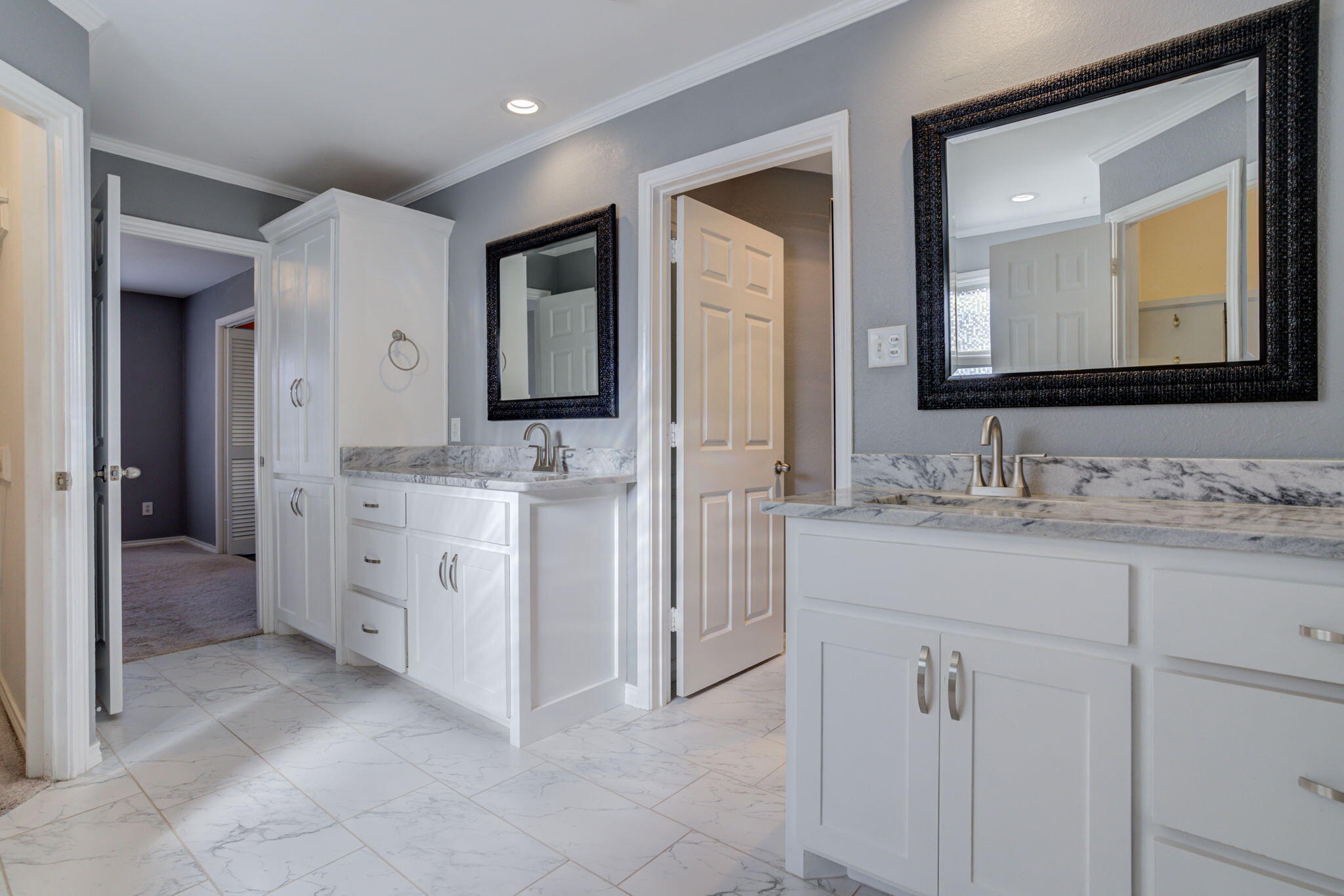 5107 1st Place Lubbock, TX 79416 - Photo 40 of 67 a bathroom with a double vanity sink and a mirror