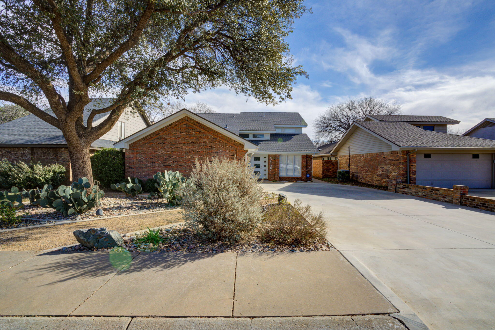 5107 1st Place Lubbock, TX 79416 - Photo 4 of 67 a front view of a house with a yard and garage