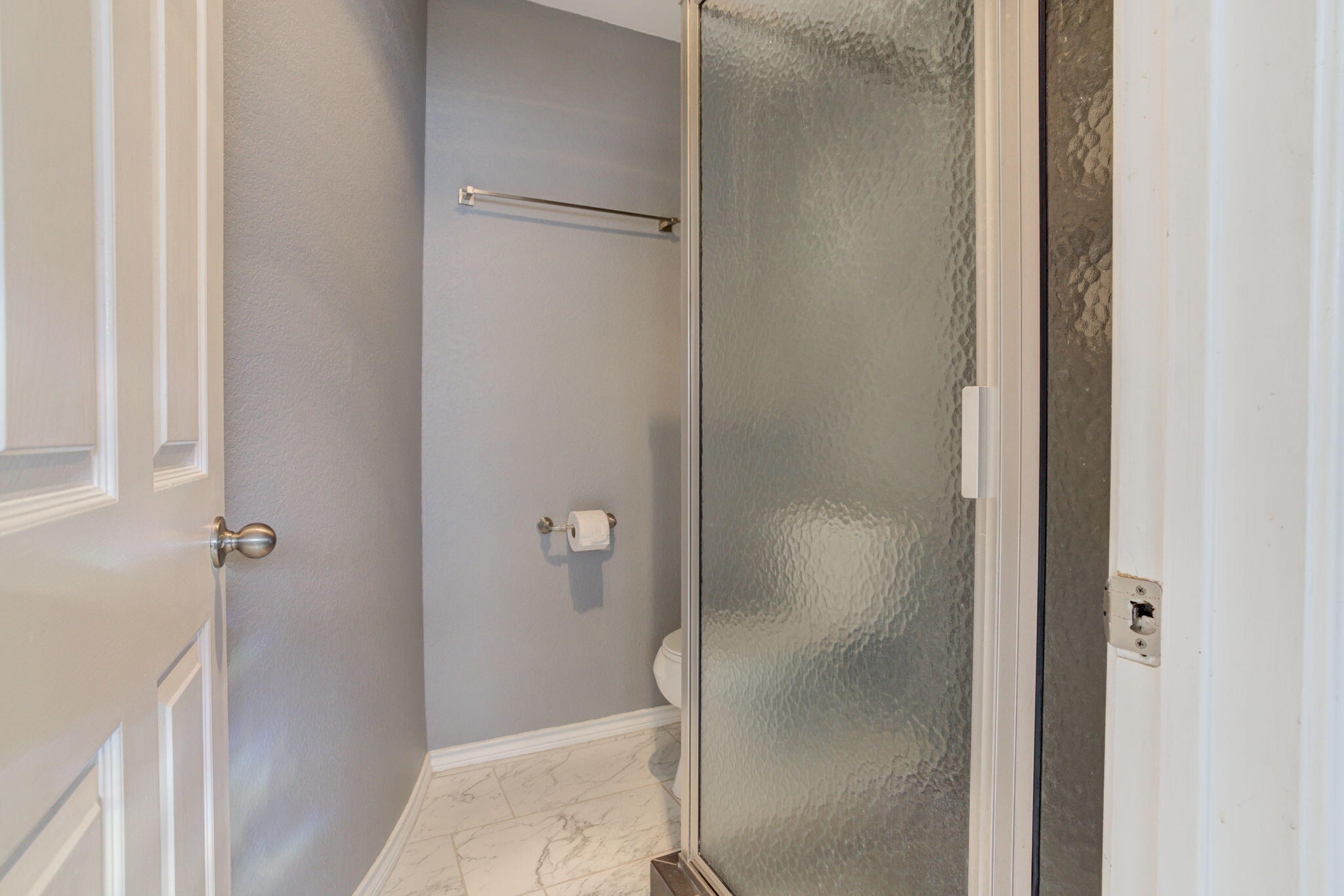 5107 1st Place Lubbock, TX 79416 - Photo 46 of 67 a bathroom with a glass shower door