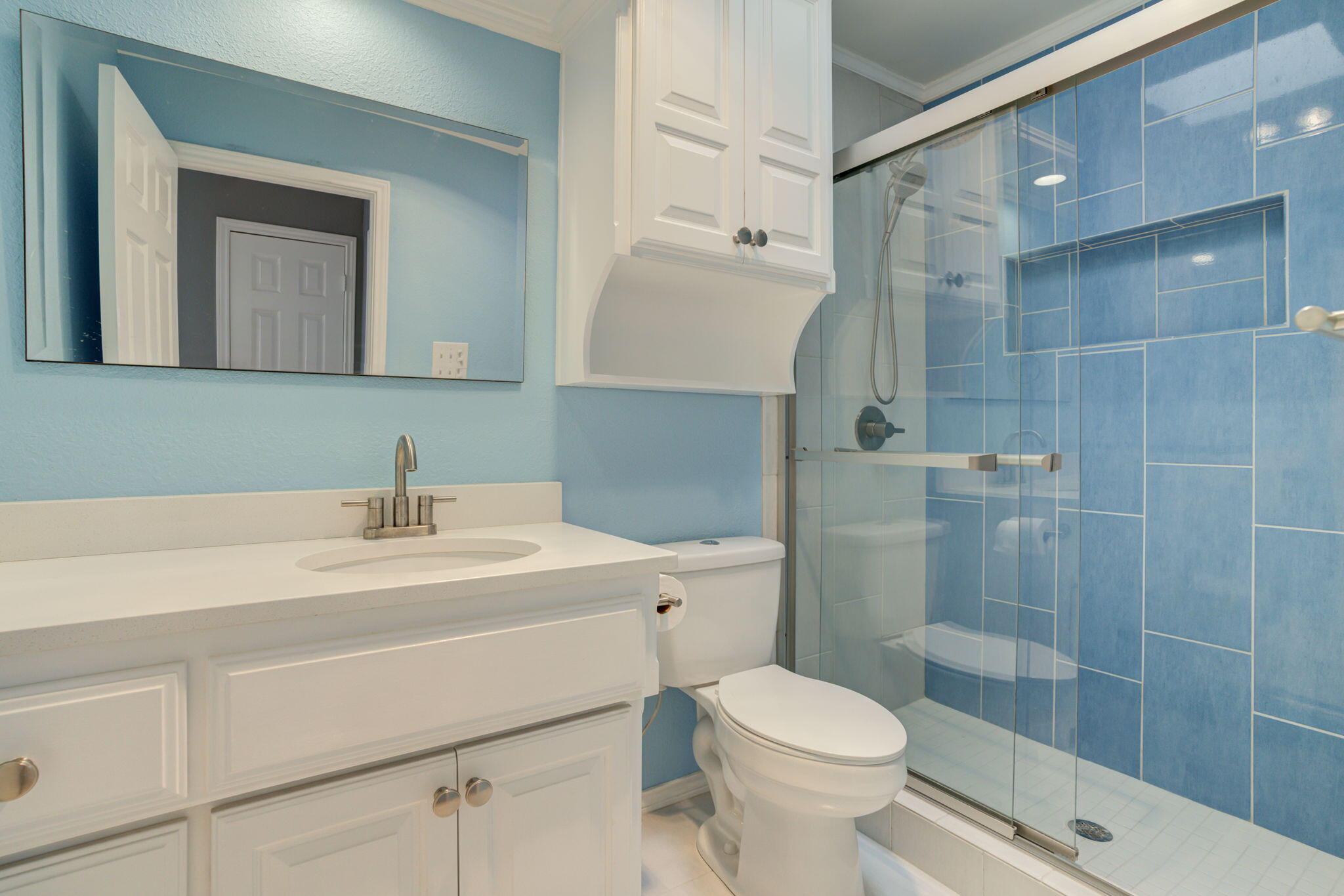 5107 1st Place Lubbock, TX 79416 - Photo 51 of 67 a bathroom with a sink toilet vanity and shower
