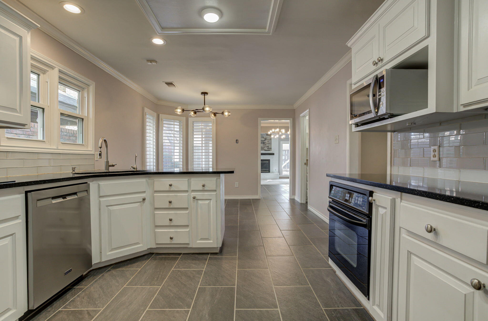 5107 1st Place Lubbock, TX 79416 - Photo 10 of 67 a kitchen with stainless steel appliances a stove sink and cabinets