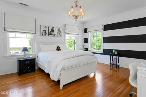 a spacious bedroom with a bed and a table in it