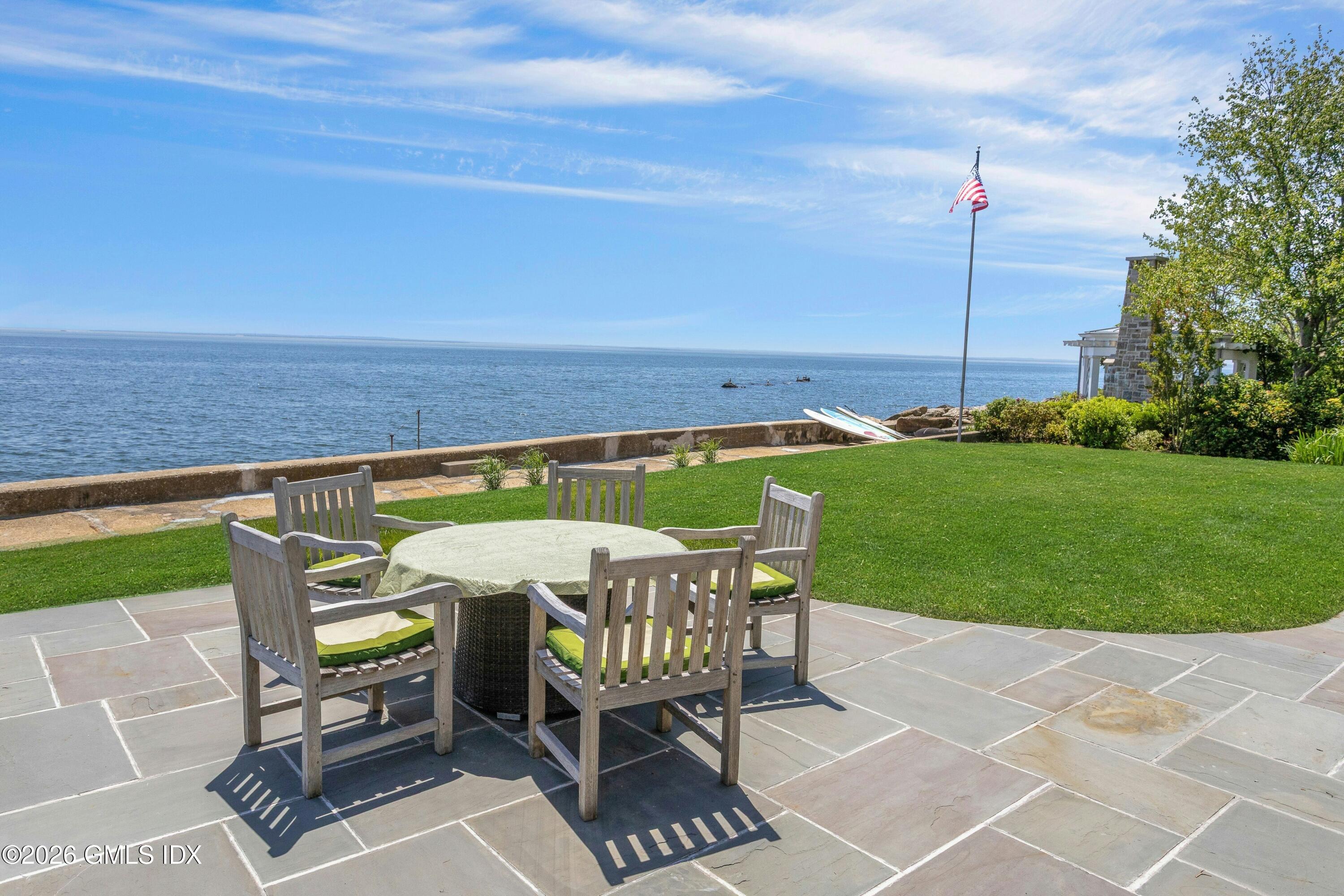 200 Shore Road Old Greenwich, CT 06870 - Photo 25 of 34 a patio with table and chairs