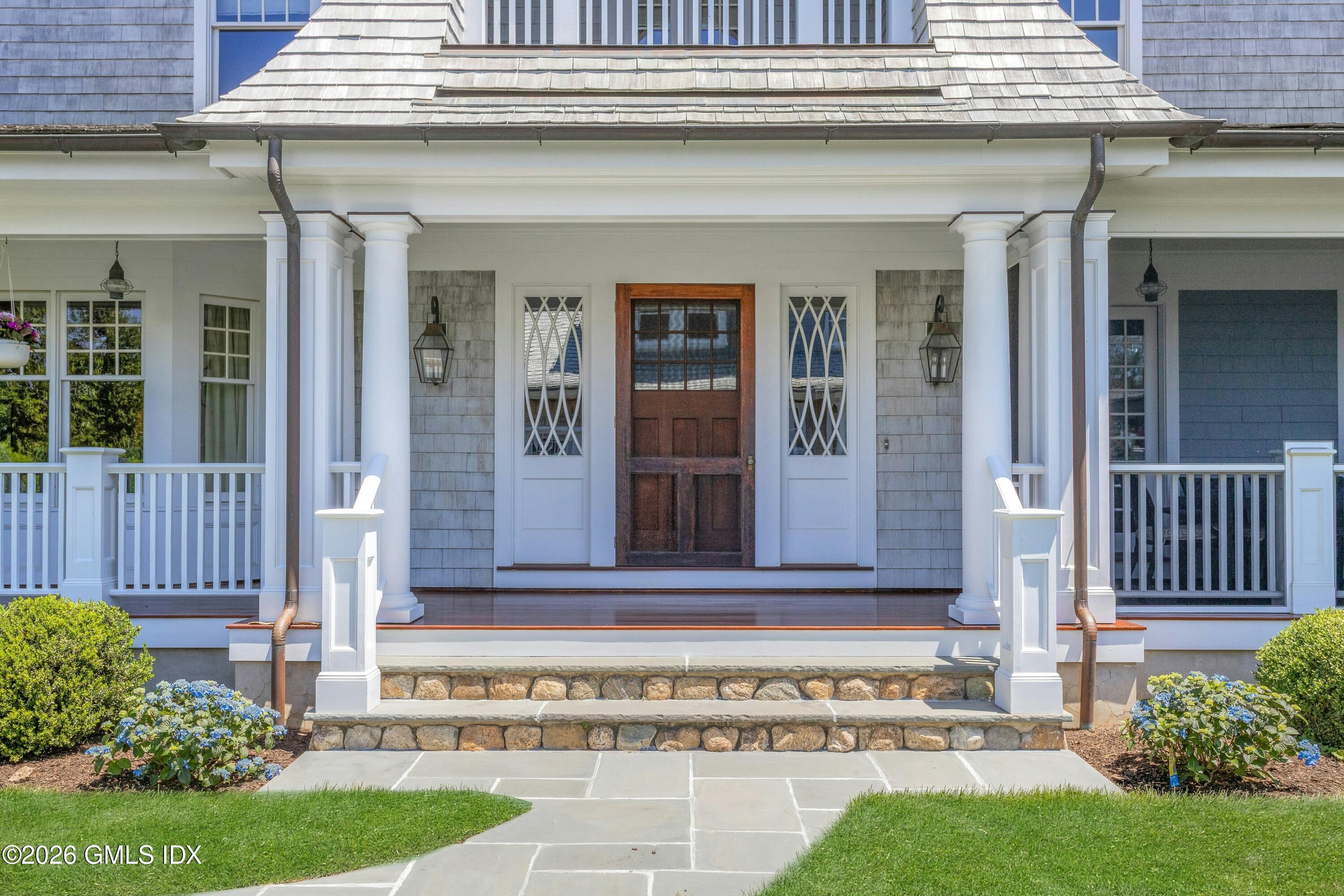 200 Shore Road Old Greenwich, CT 06870 - Photo 28 of 34 a view of a house with a small yard and plants