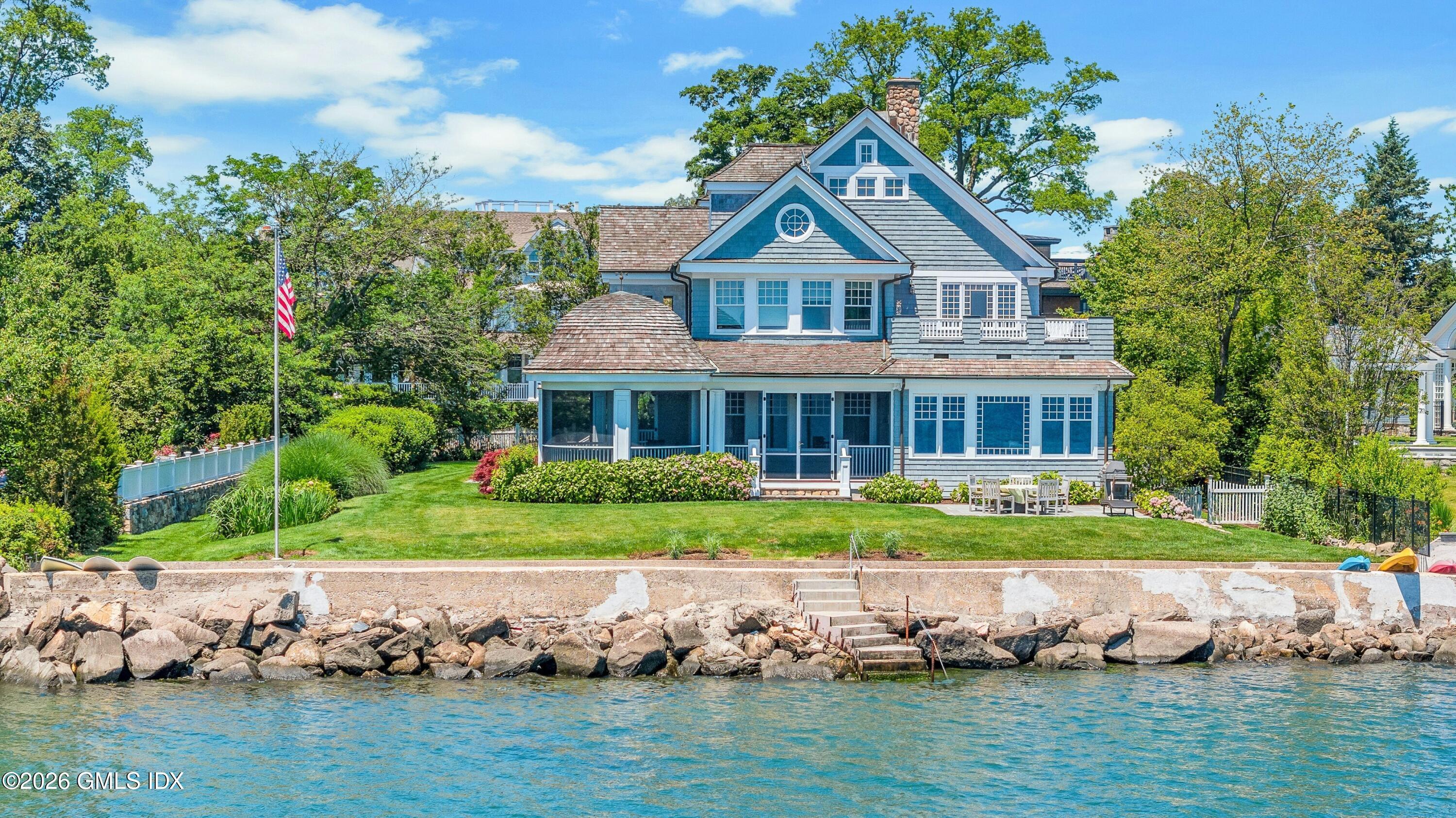 200 Shore Road Old Greenwich, CT 06870 - Photo 32 of 34 a front view of a house with a yard