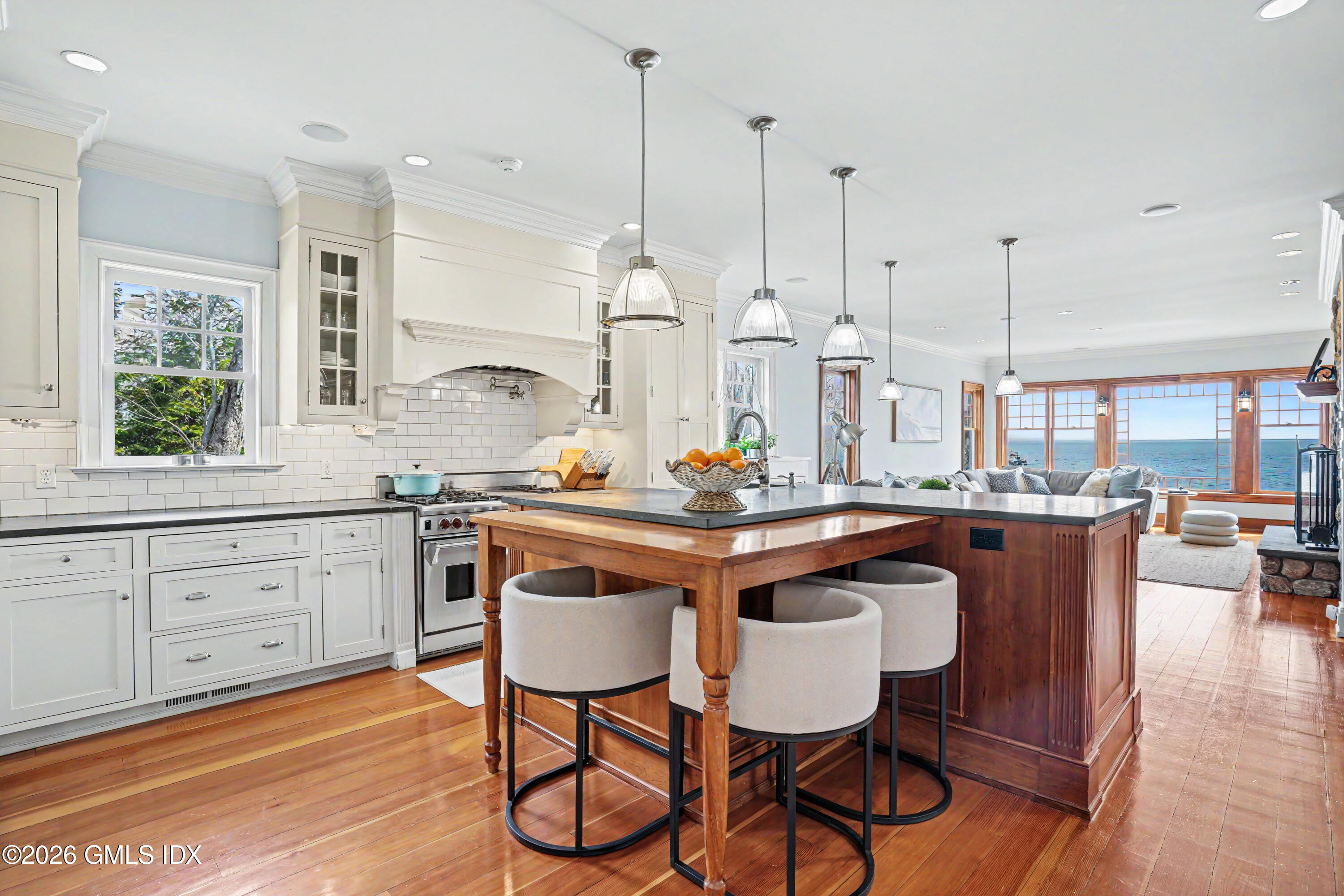 200 Shore Road Old Greenwich, CT 06870 - Photo 5 of 34 a kitchen with stainless steel appliances granite countertop wooden floors and white cabinets