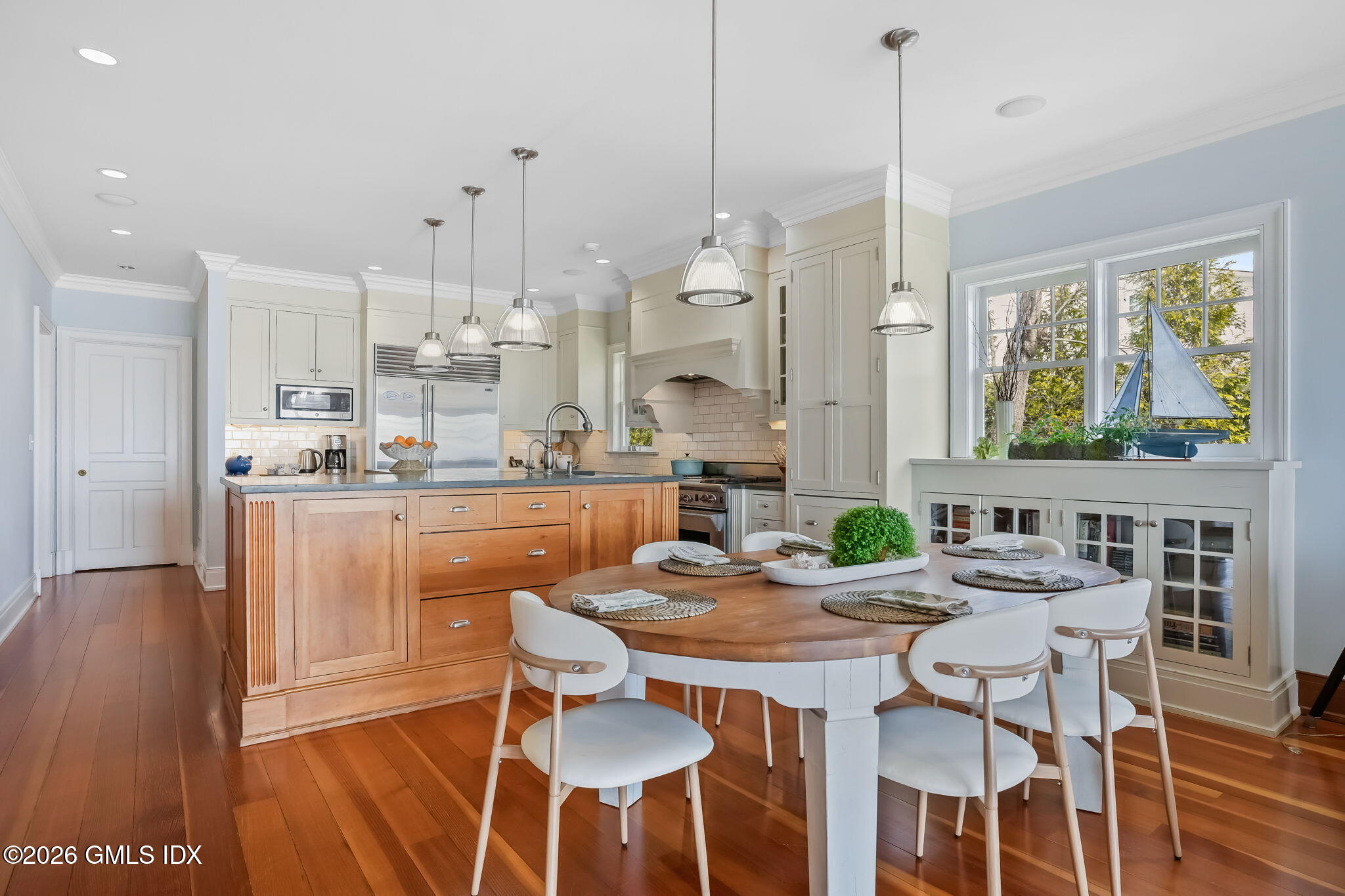 200 Shore Road Old Greenwich, CT 06870 - Photo 7 of 34 a dining room with furniture a chandelier and wooden floor