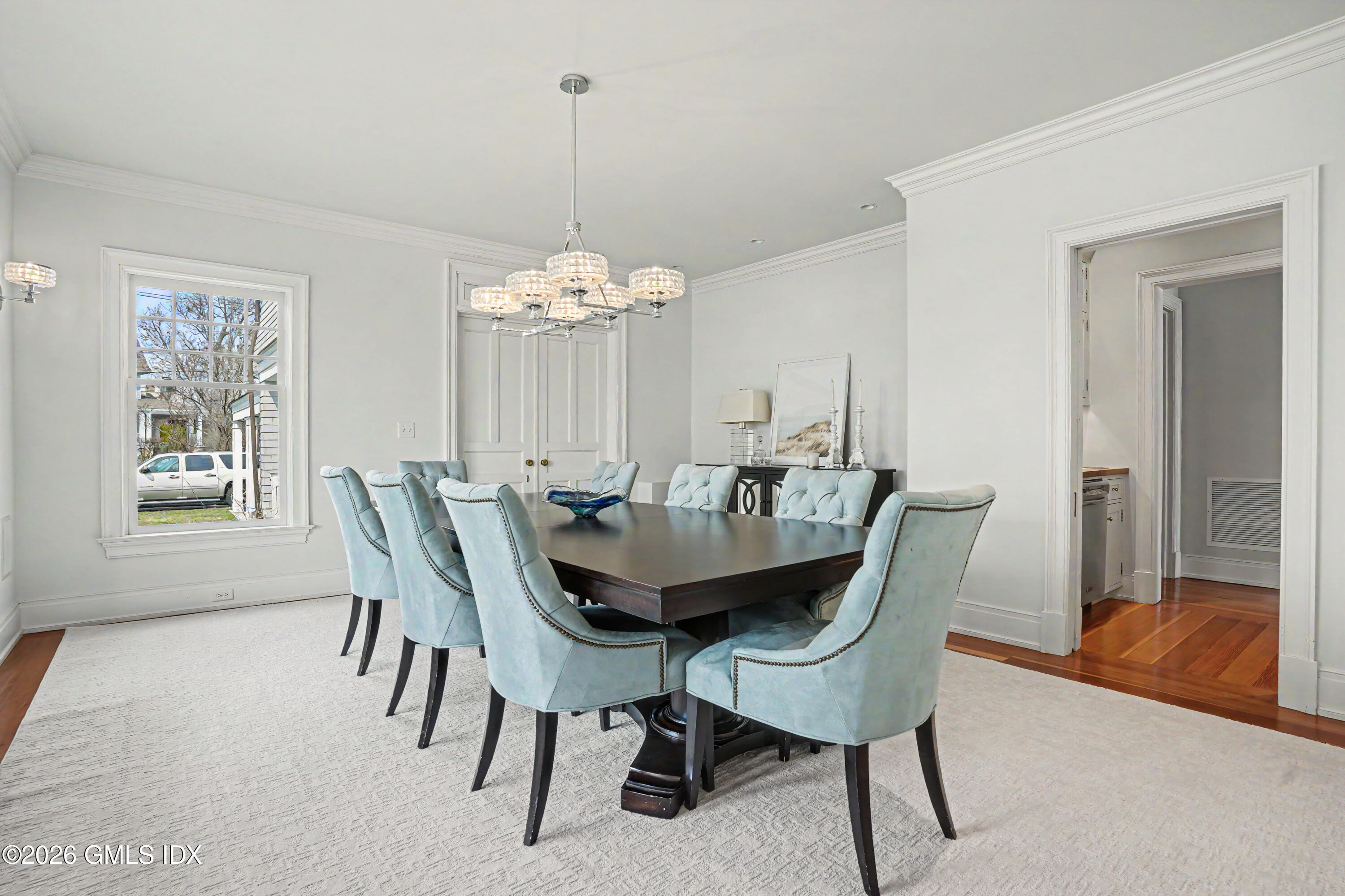 200 Shore Road Old Greenwich, CT 06870 - Photo 9 of 34 a dining room with furniture a chandelier and wooden floor