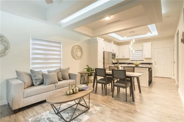 a living room with furniture and kitchen view