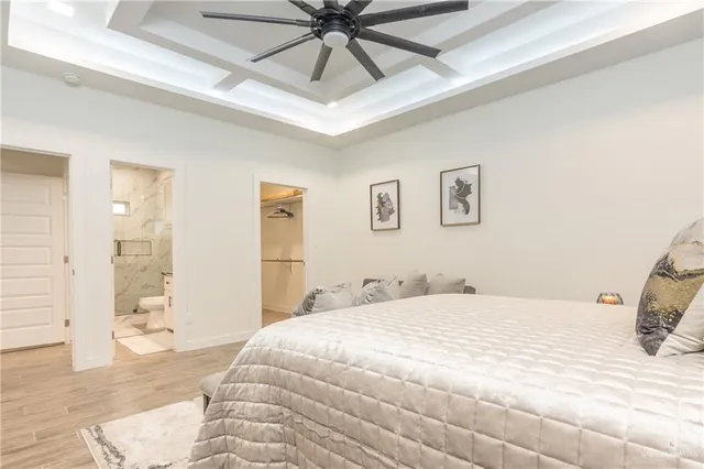 a bedroom with a bed and a chandelier