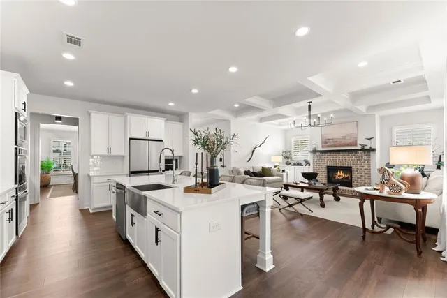 a kitchen with a sink a microwave and cabinets