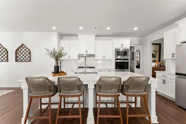 a dining room with furniture a chandelier and wooden floor