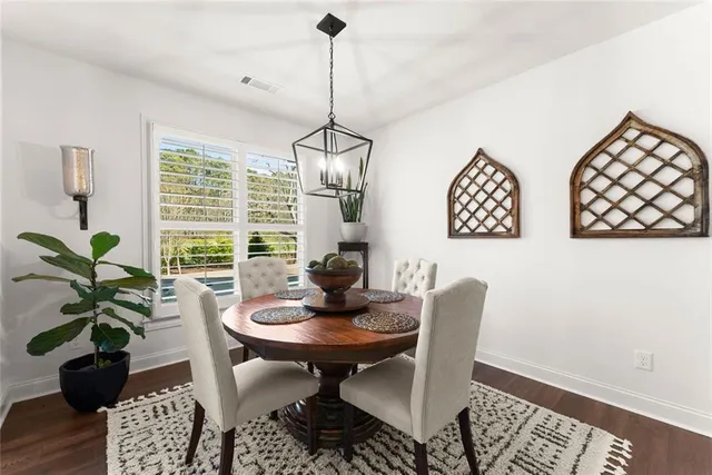 a living room with furniture a fireplace and a chandelier
