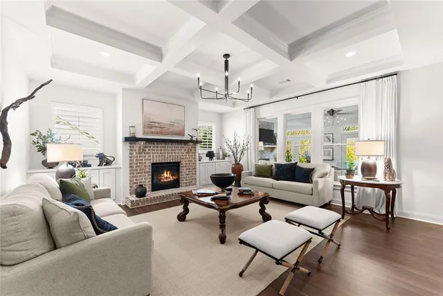 a living room with furniture a fireplace and a chandelier