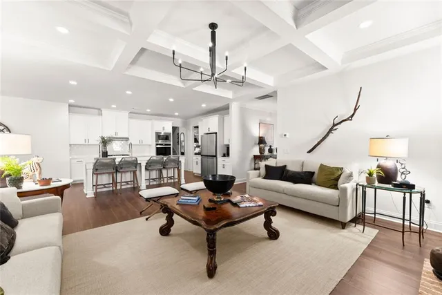a living room with furniture a fireplace and a floor to ceiling window