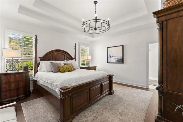 a spacious bathroom with a granite countertop sink mirror and bathtub