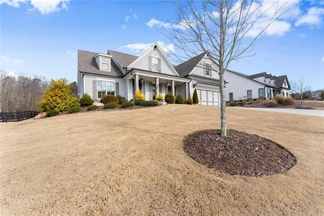 a front view of a house with a garden