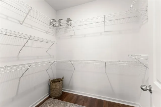 a living room with furniture and a flat screen tv with kitchen view