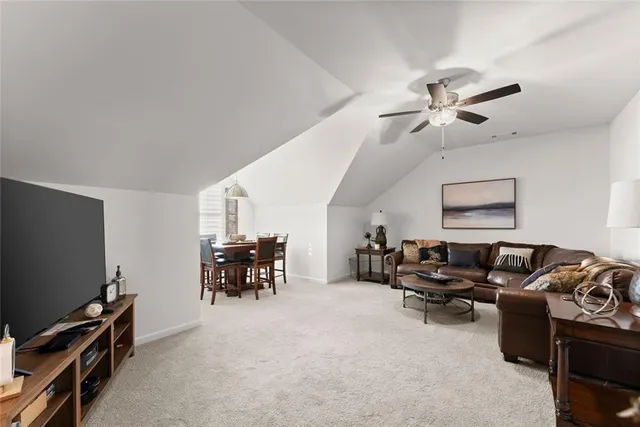 a room with a bed cabinets and a window