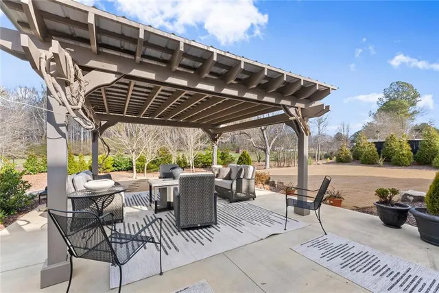 a view of a house with backyard and sitting area