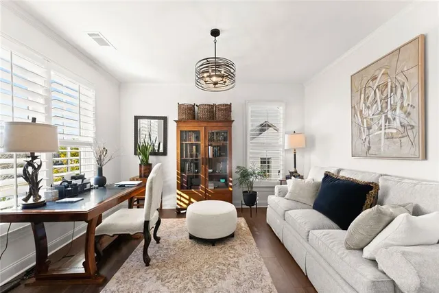 a living room with furniture chess table and a window